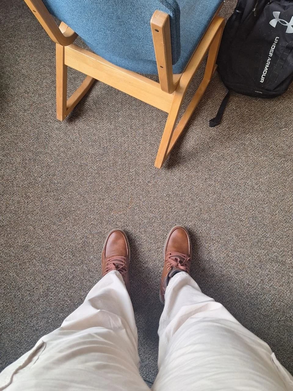 Brown shoes and white trousers, looking down