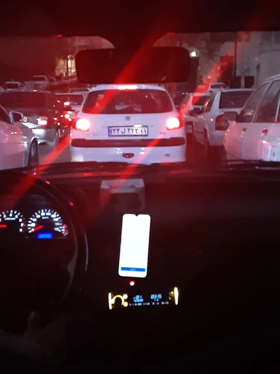 Red tail lights on a city street at night