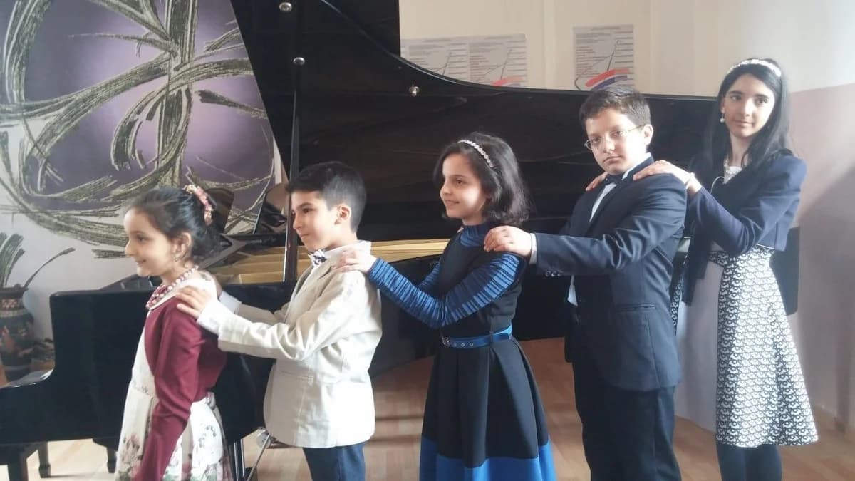 Children sharing a piano bench